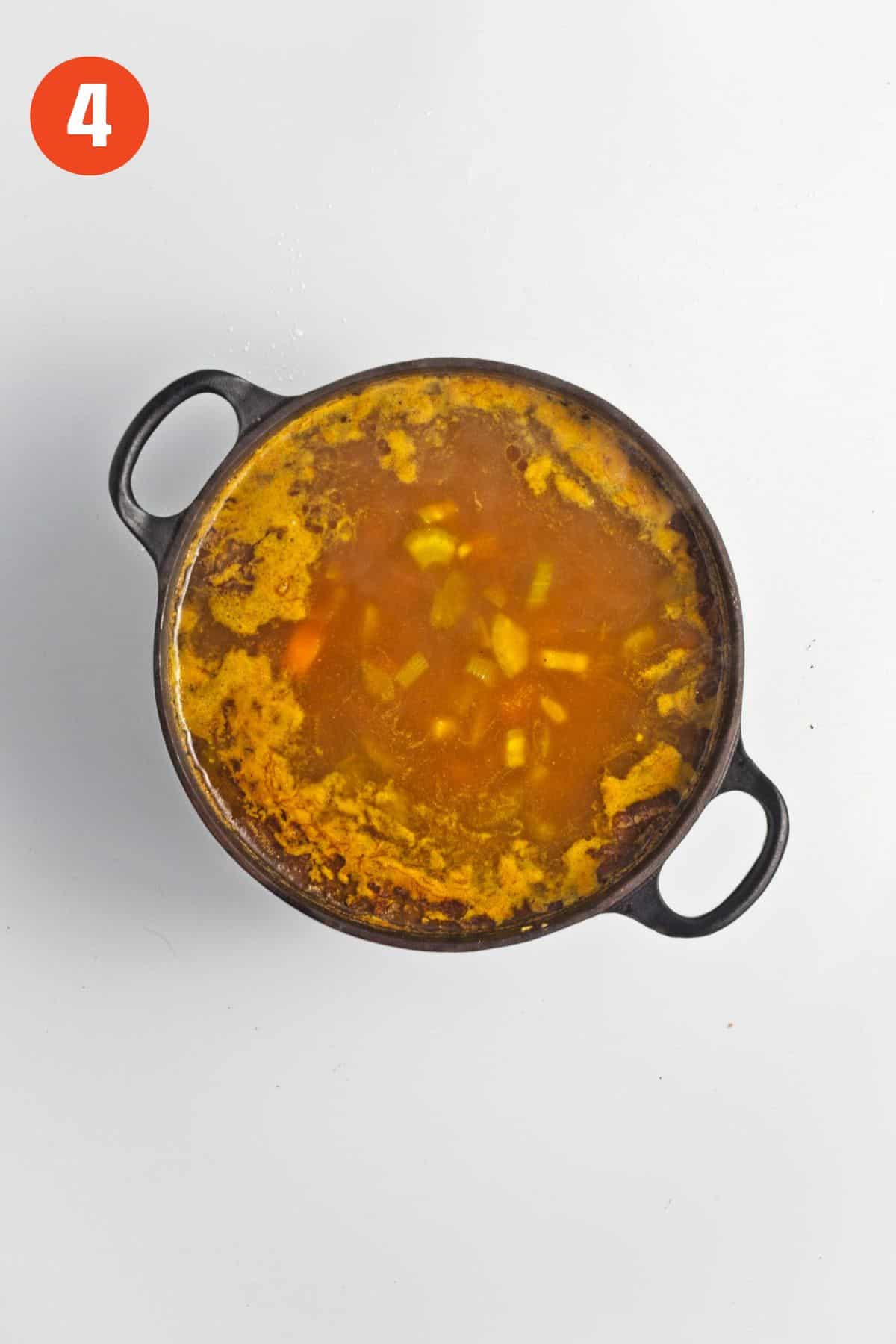 Curried carrot soup after cooking in a pot.