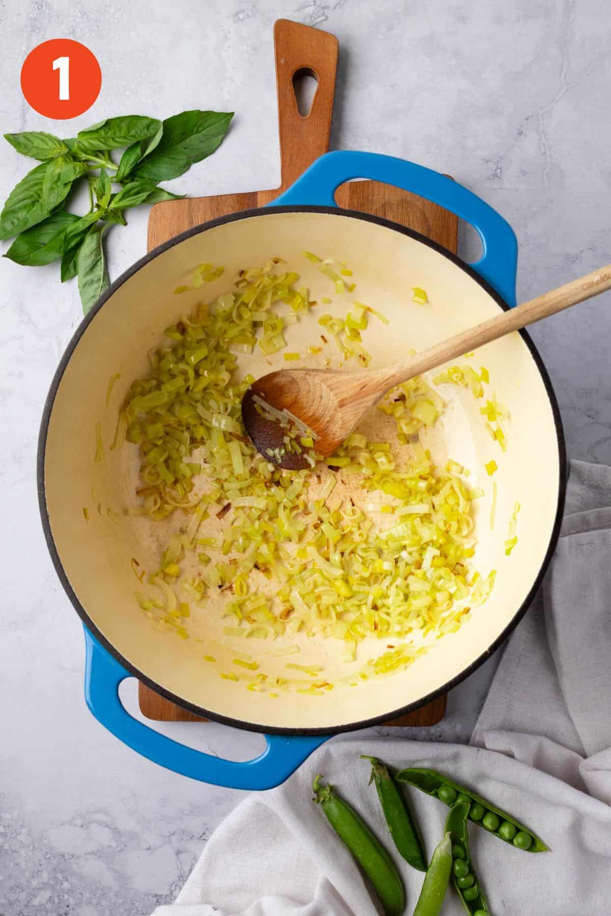 Leeks cooking in a large soup pot.