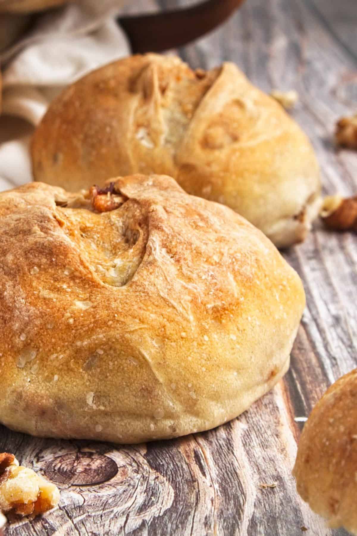 A side view of crusty dinner rolls on the table. 