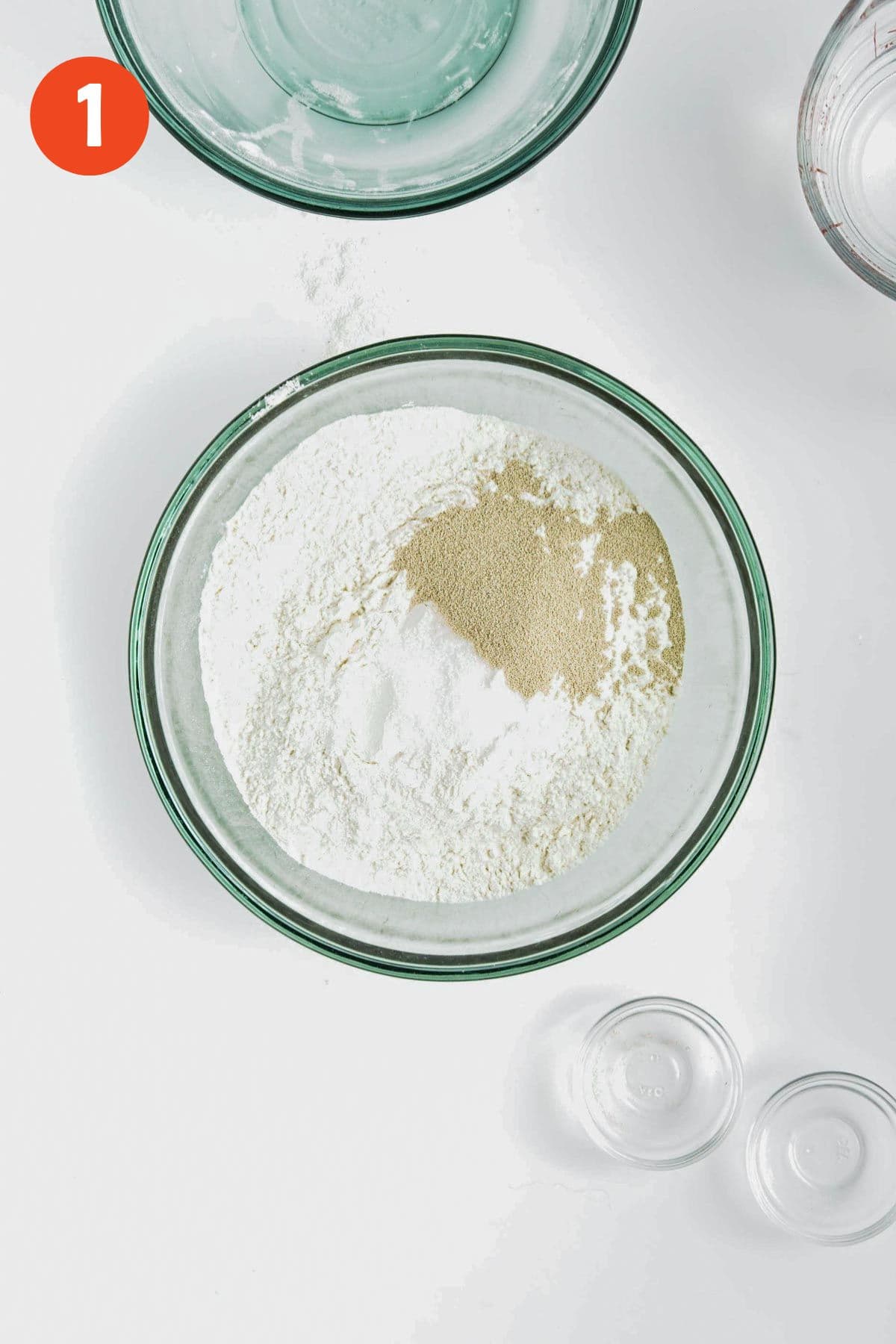 Ingredients to make crusty rolls in a bowl.