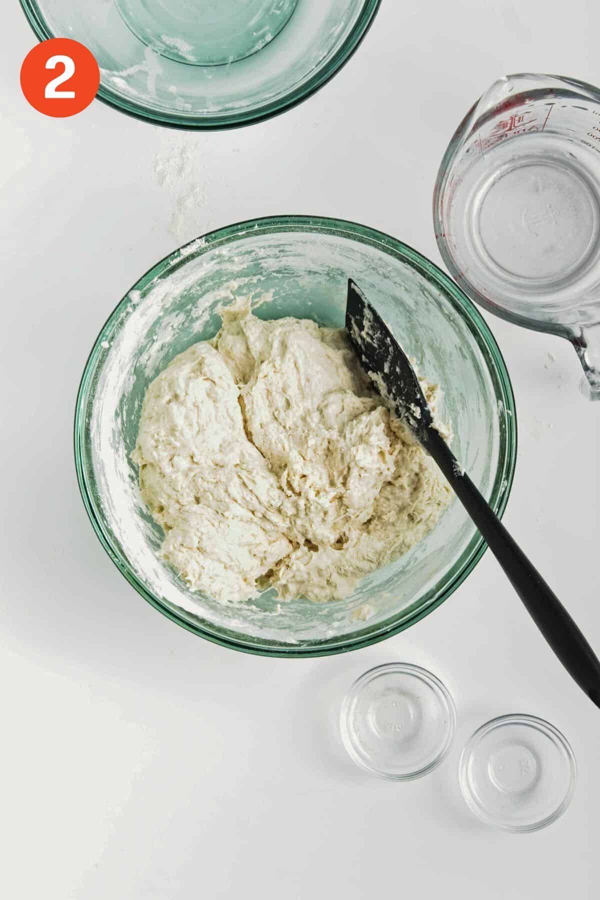 Homemade dinner roll dough mixed in a bowl.
