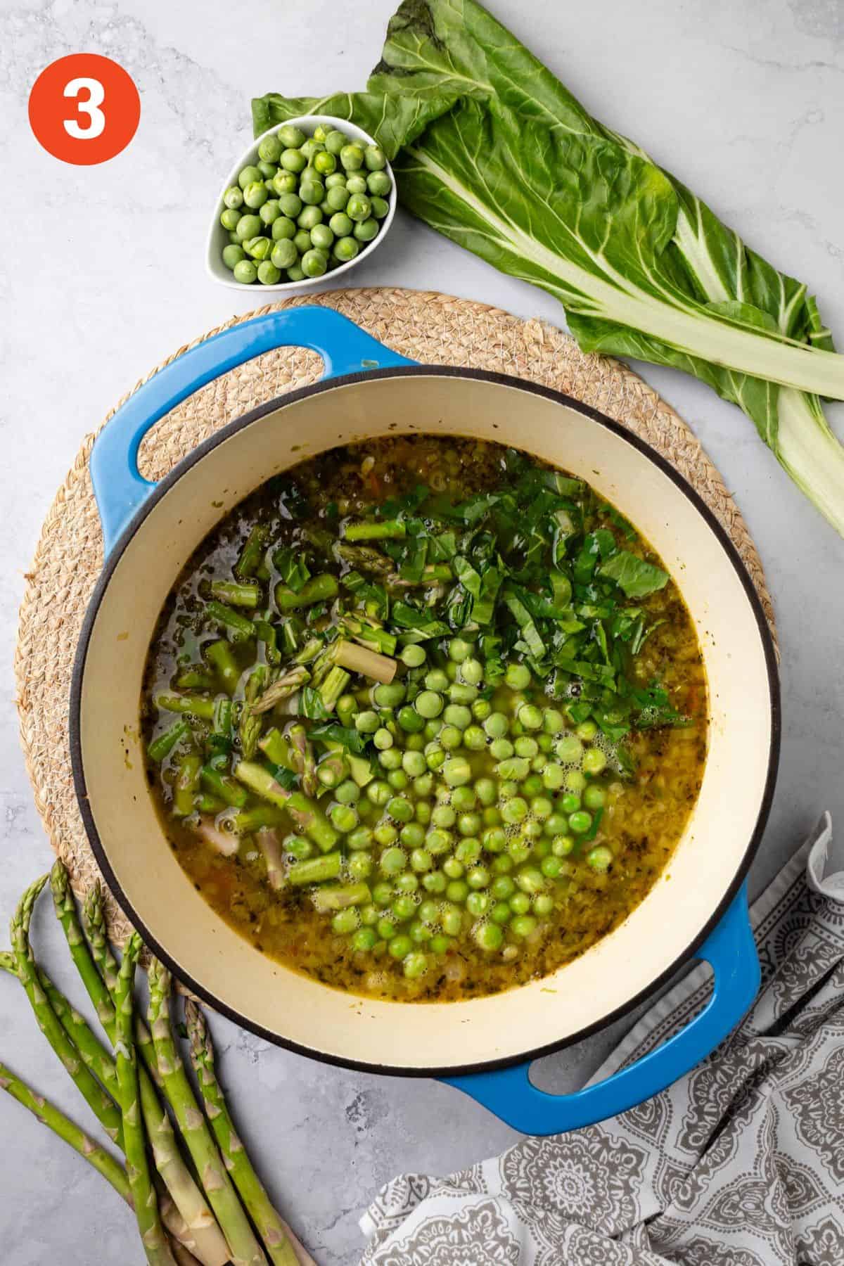 Peas, asparagus, and chard added to pot to cook.