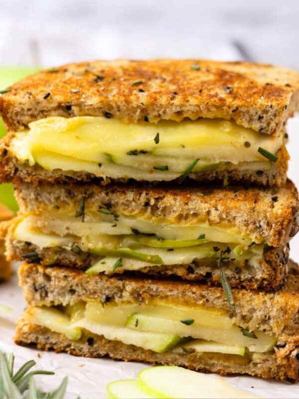 Brie grilled cheese halves stacked on top of each other.