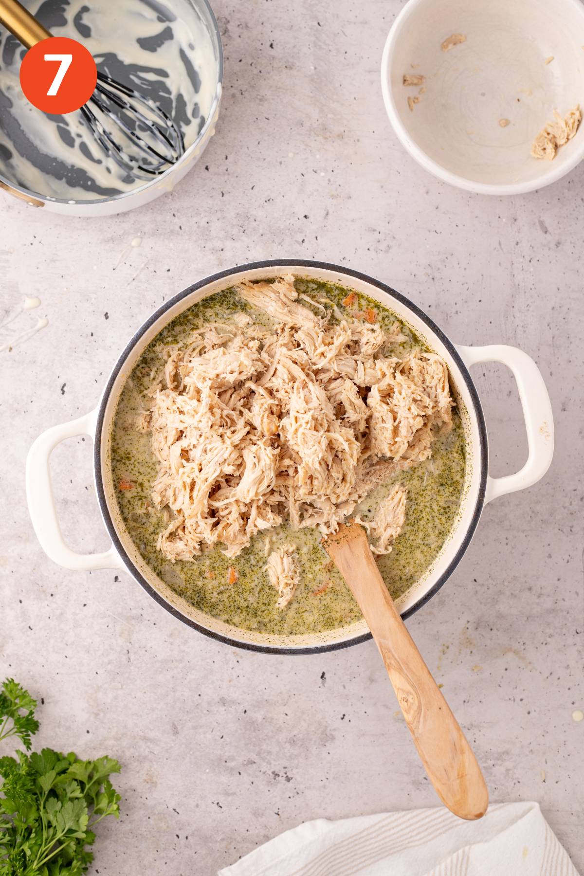 Chicken added to the pot of soup.