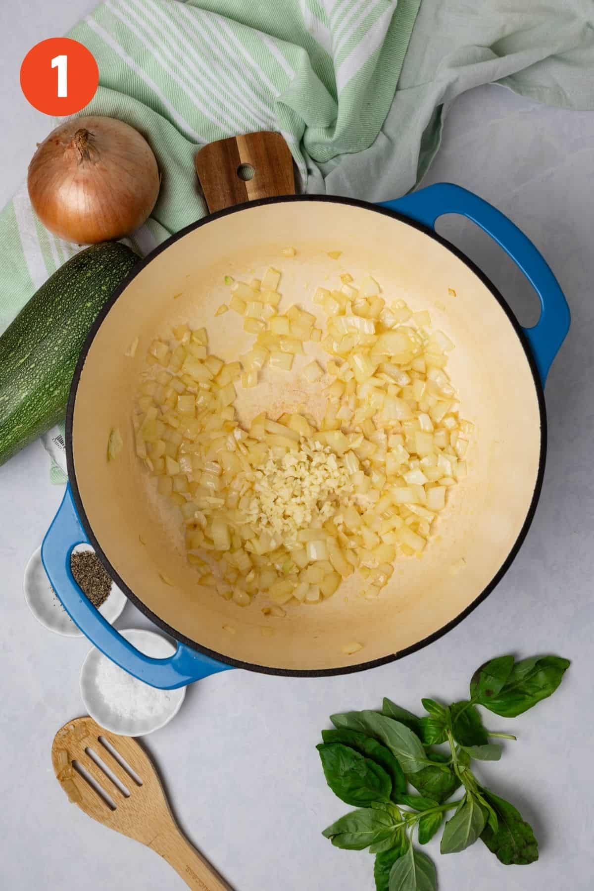 Onion and garlic cooking in a large Dutch oven.