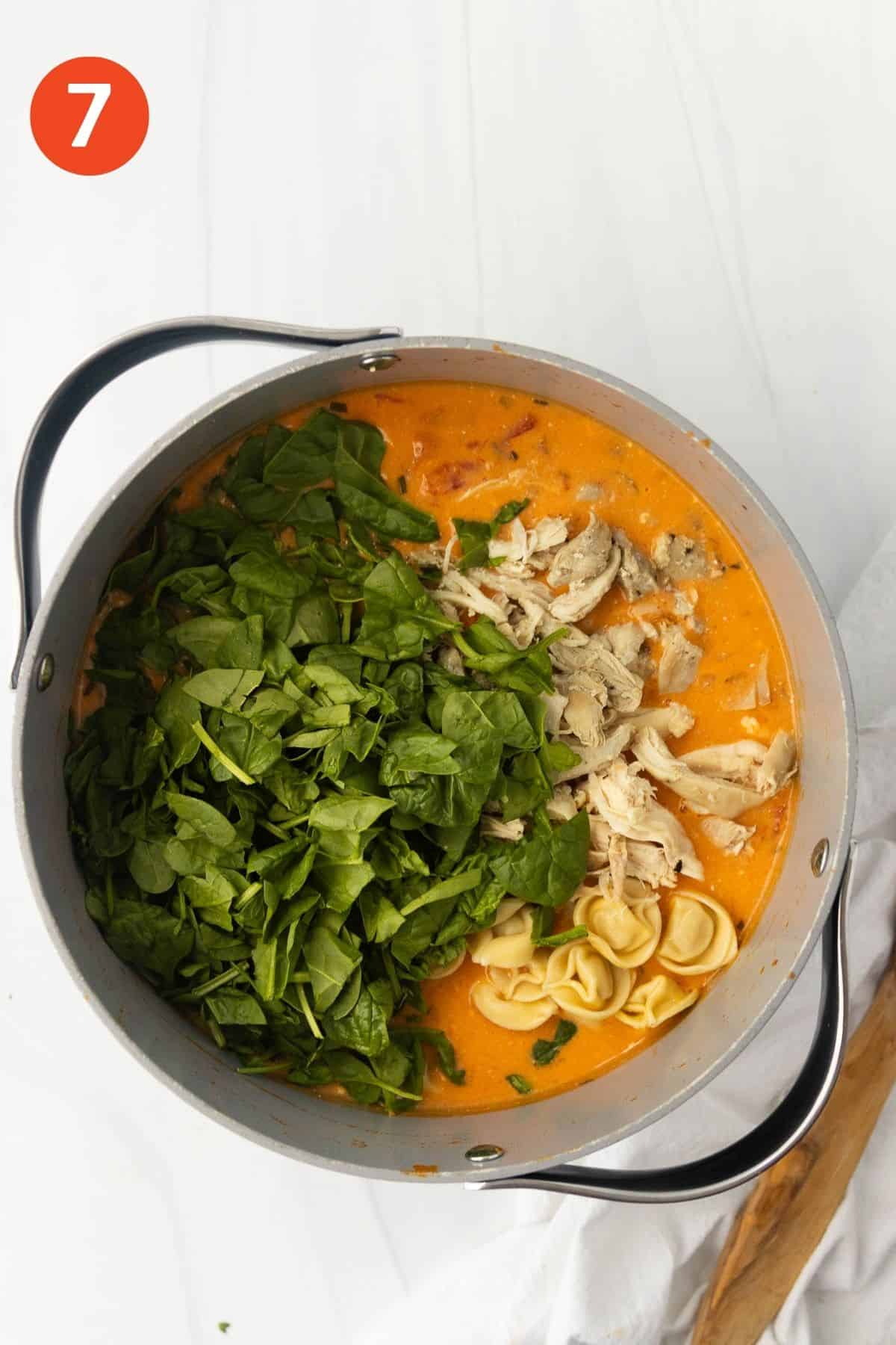 Chicken and spinach added to the pot of soup.