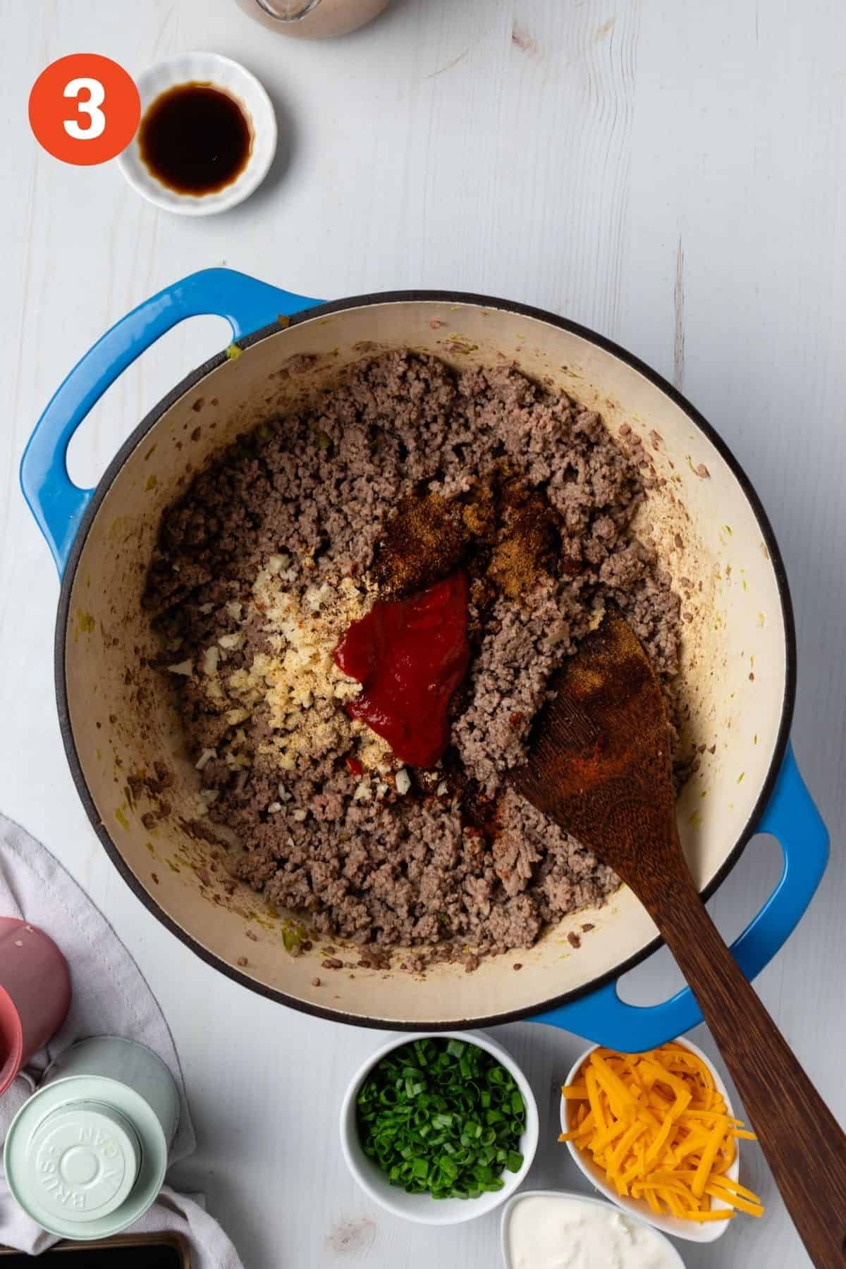 Spices and tomato paste added to the pot.