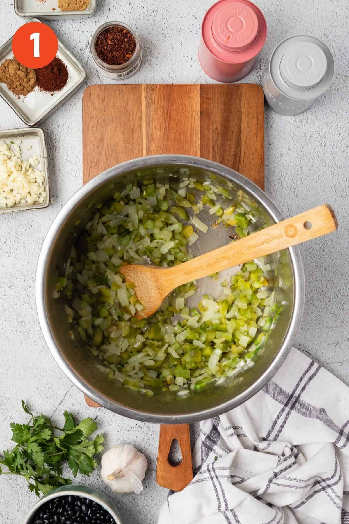 Cooking the onions, celery, and bell pepper.