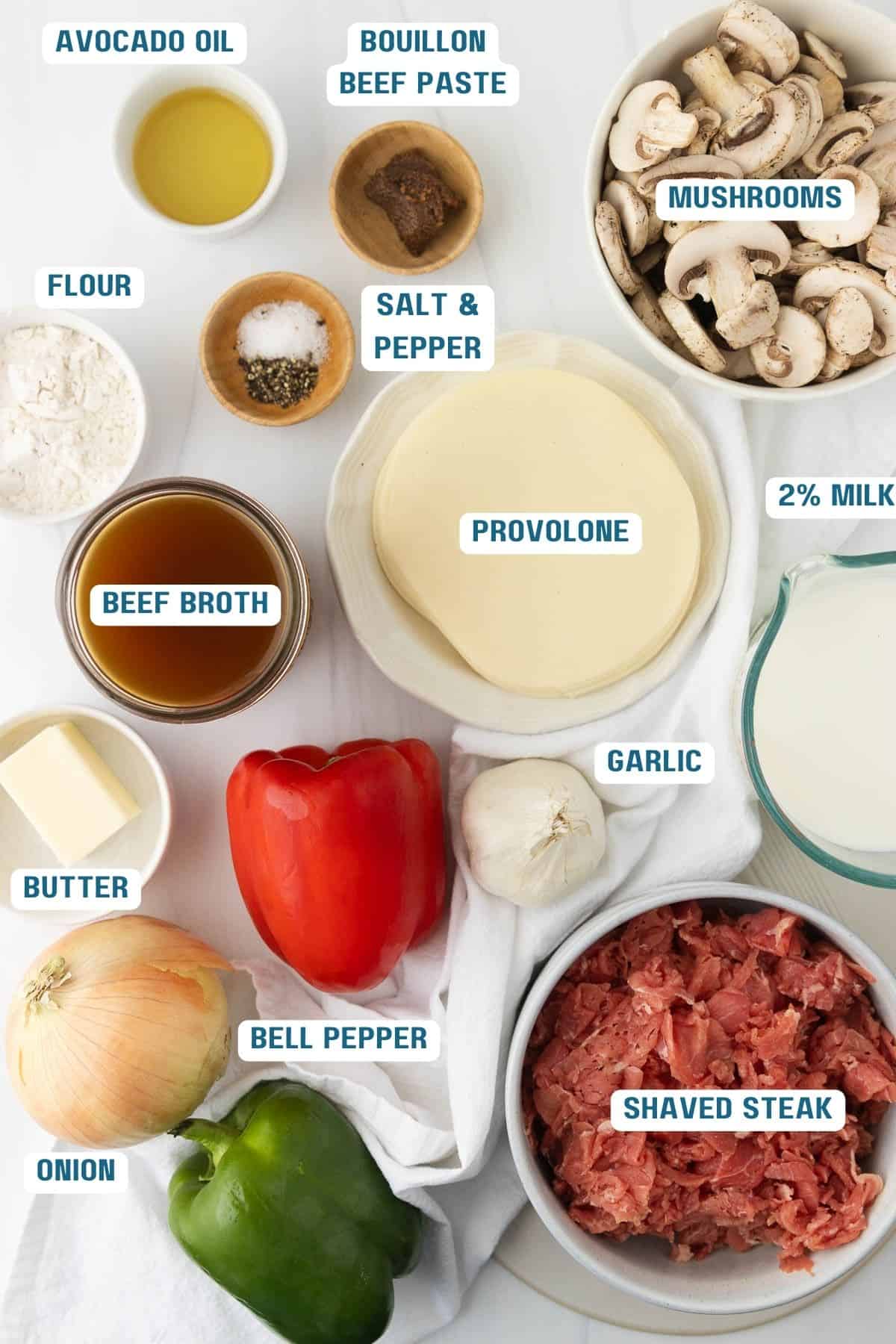 Ingredients to make philly steak soup in bowls with labels.