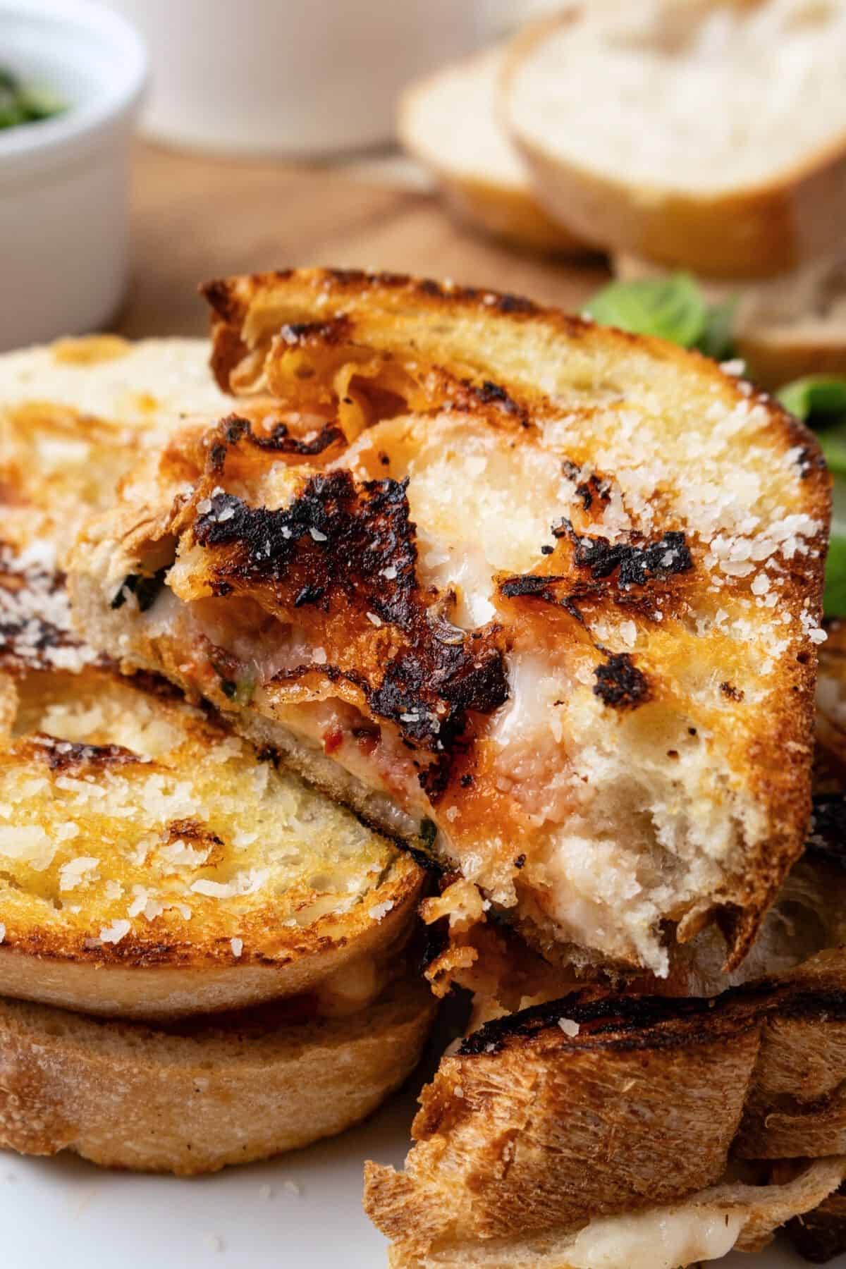 Half a pizza grilled cheese on top of two other halves. 