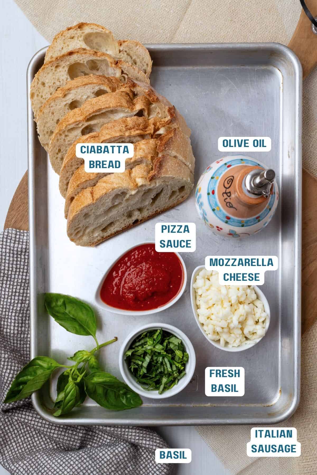 Ingredients to make a pizza grilled cheese on a baking pan. 
