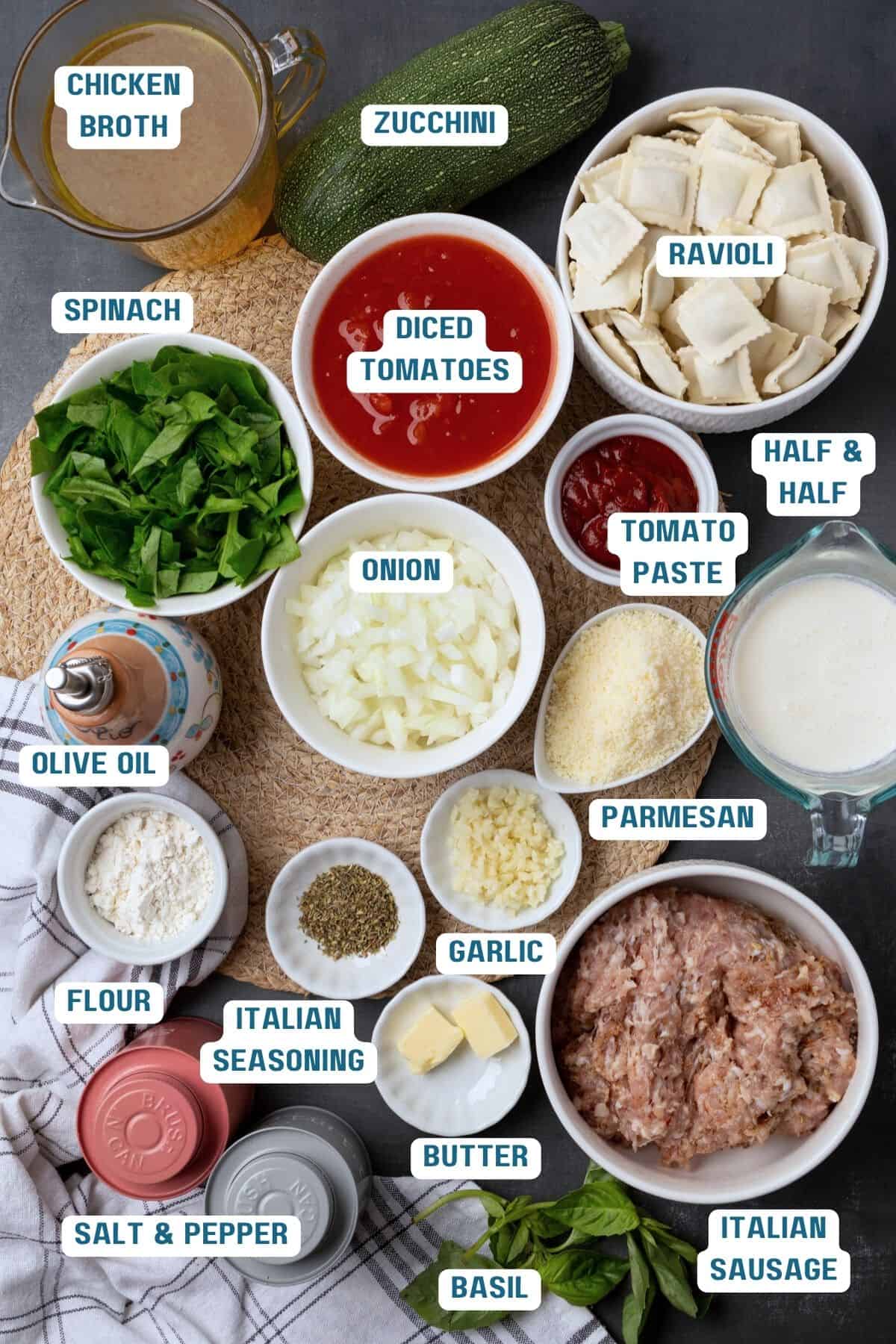 Ingredients to make ravioli soup on a table with lables to identify them.