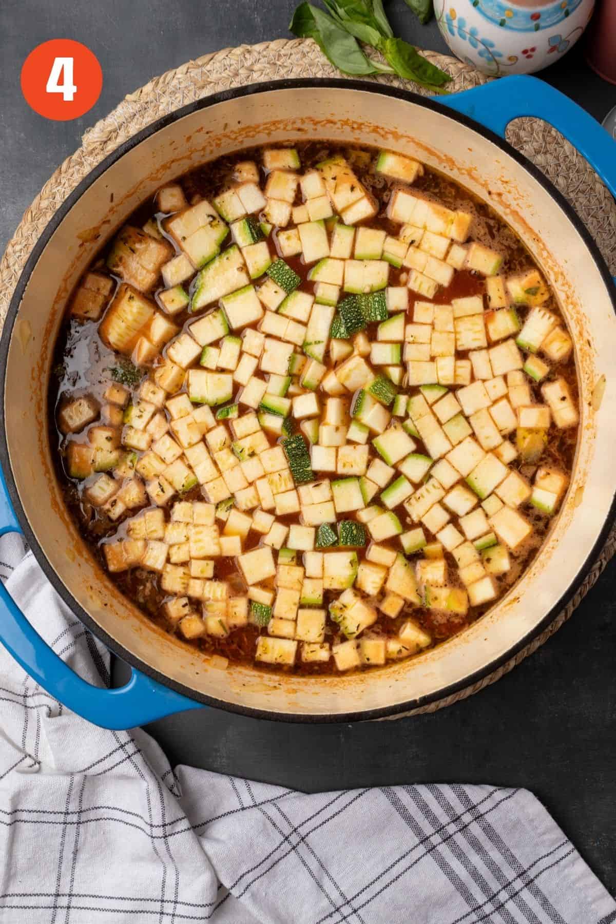Zucchini added to the soup pot to cook. 