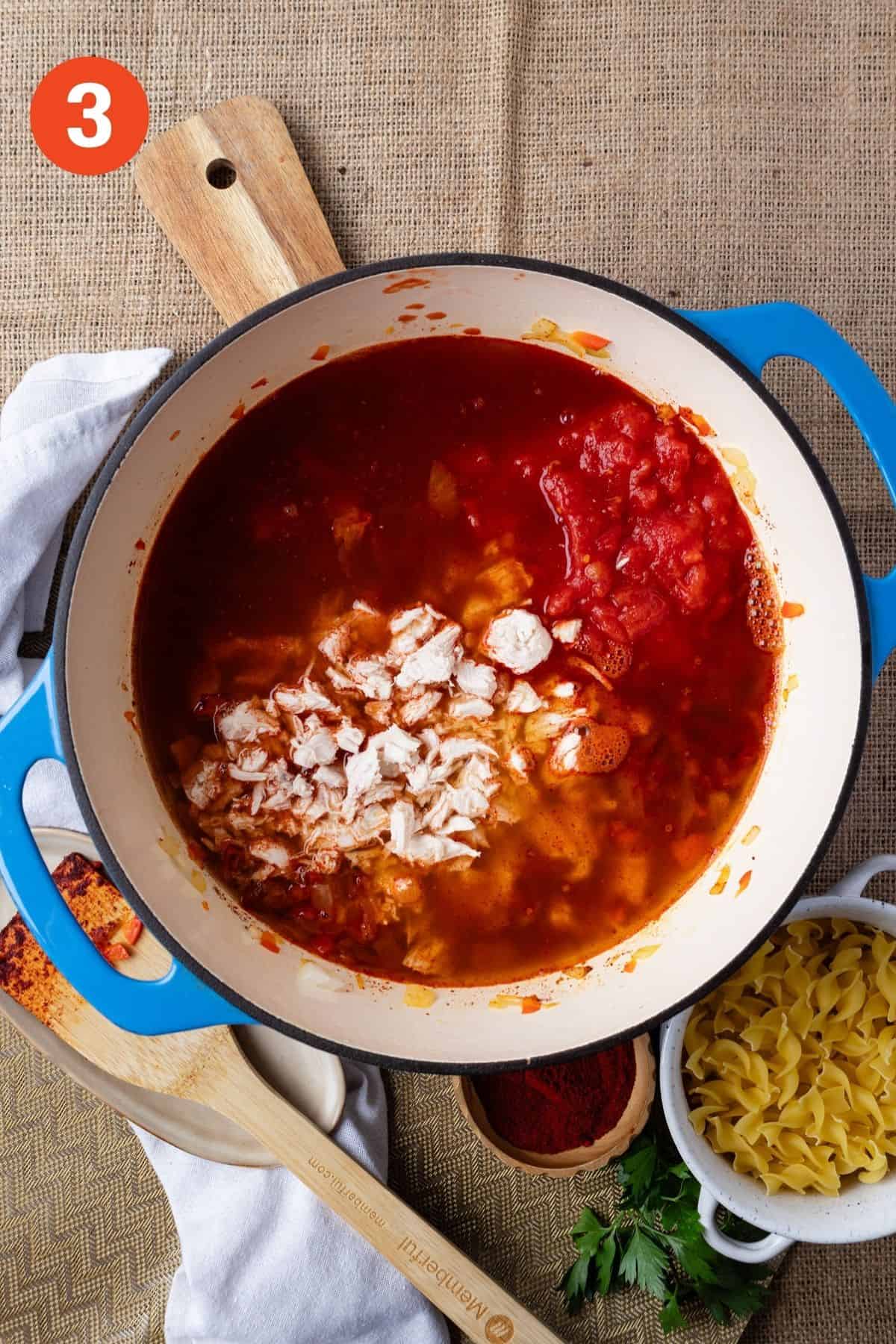Chicken, broth and tomatoes added to the pot.