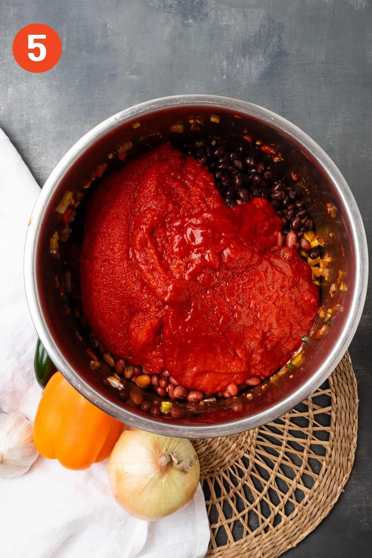 Tomatoes and broth added to the cooked ground turkey and vegetables.