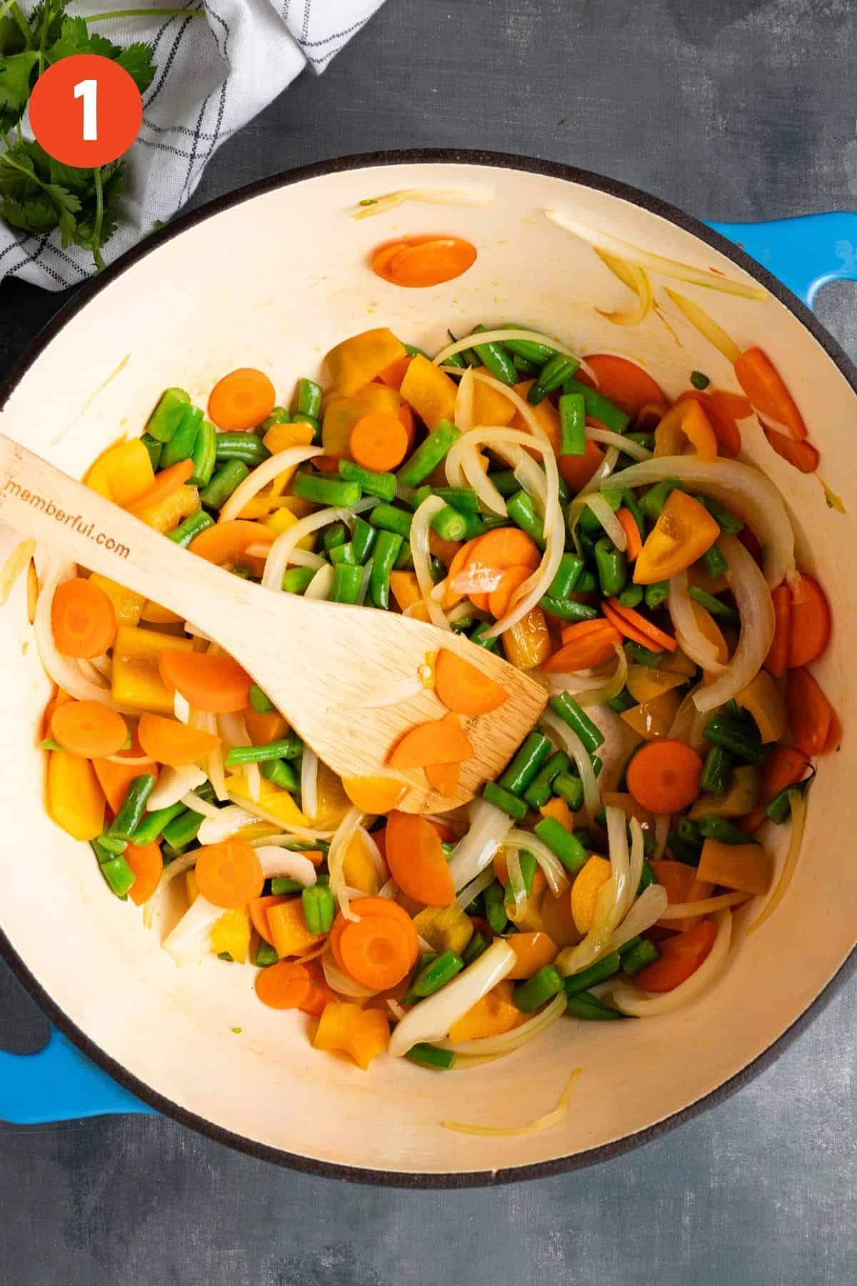 Vegetables cooking in a large pot.