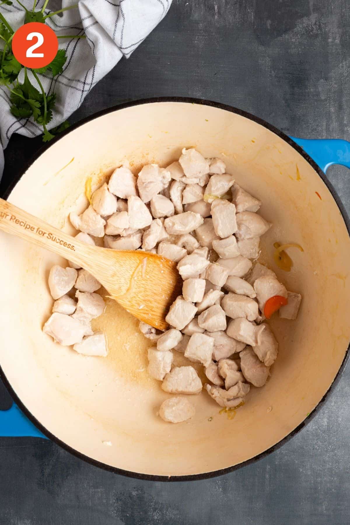 Chicken for red curry chicken soup cooking in a pot.