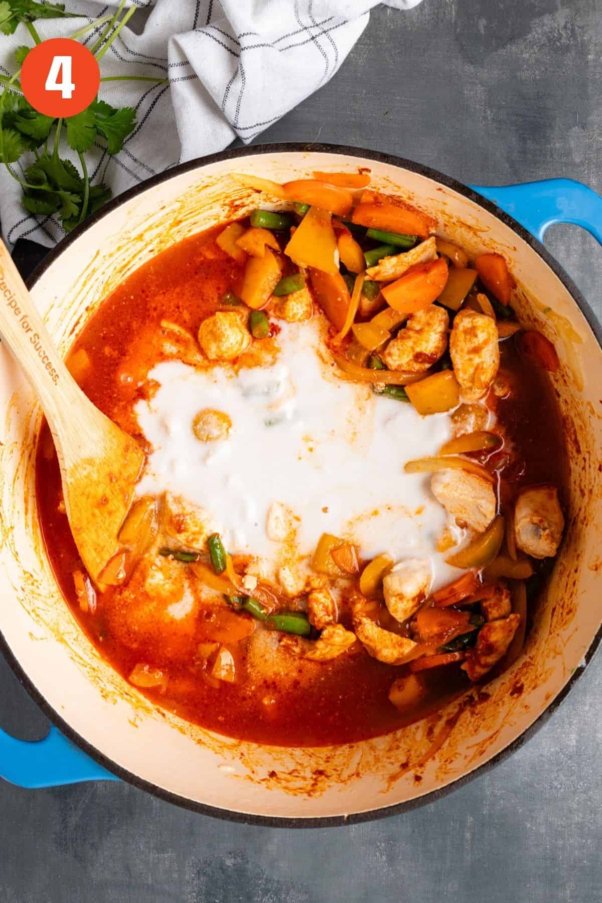 Broth and coconut milk added to the pot.