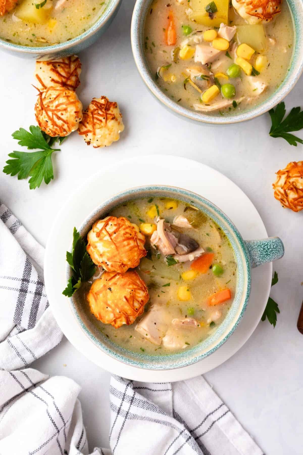 Chicken pot pie soup in bowls on a table.