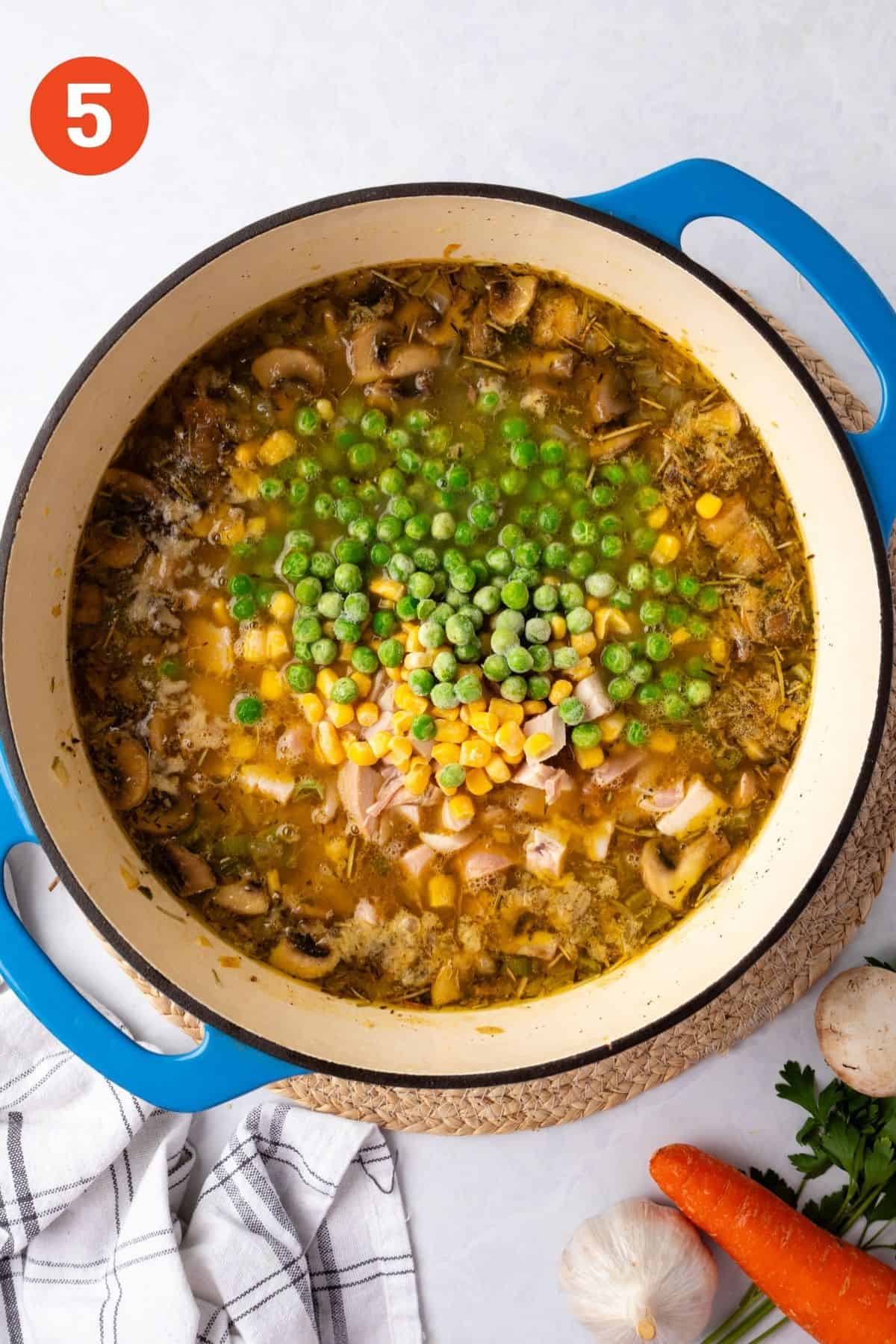 Frozen peas and corn added to the pot of soup.