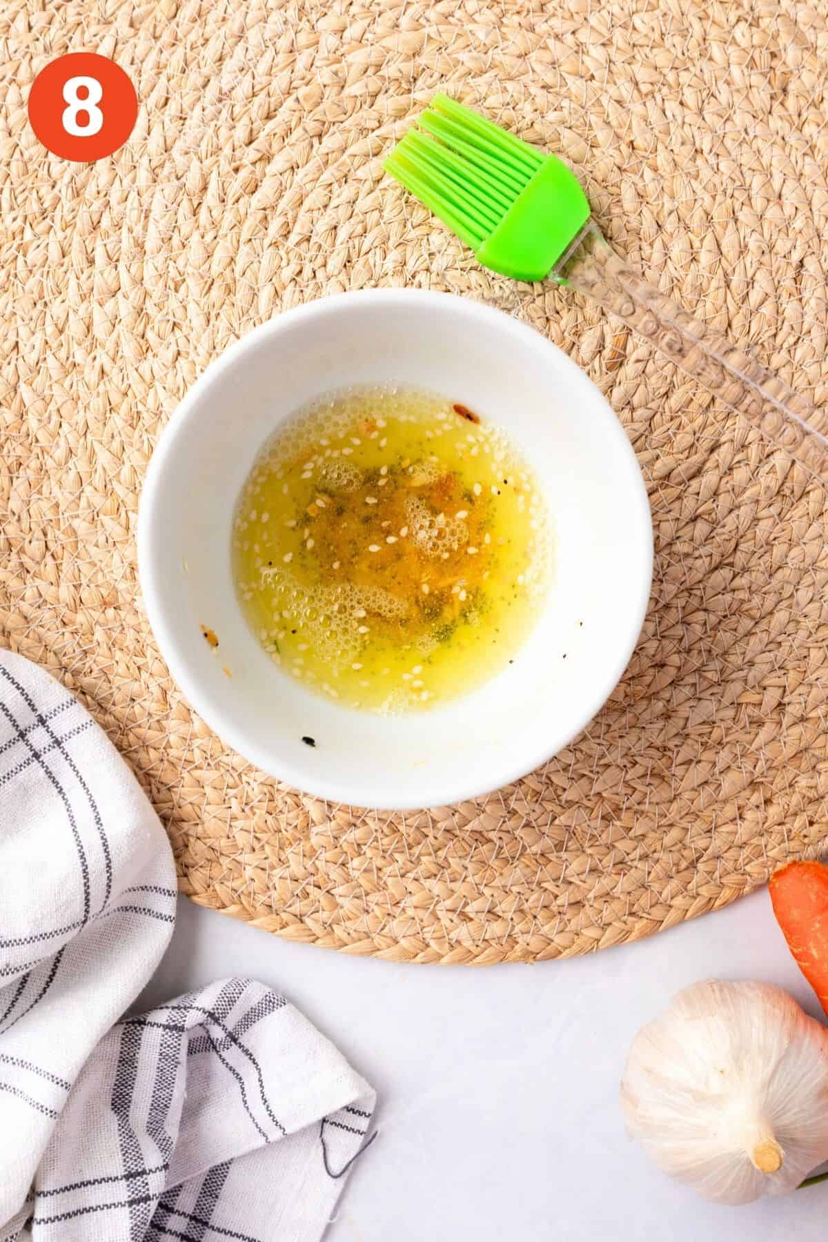 Egg whites and seasonings added to a bowl.