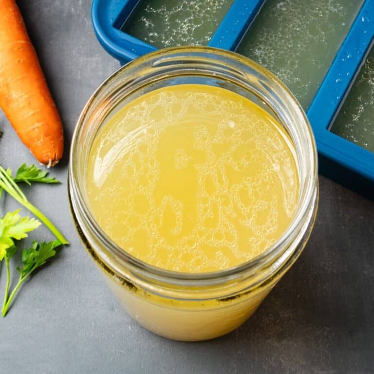 A jar of Instant Pot chicken broth next to a freezer tray.