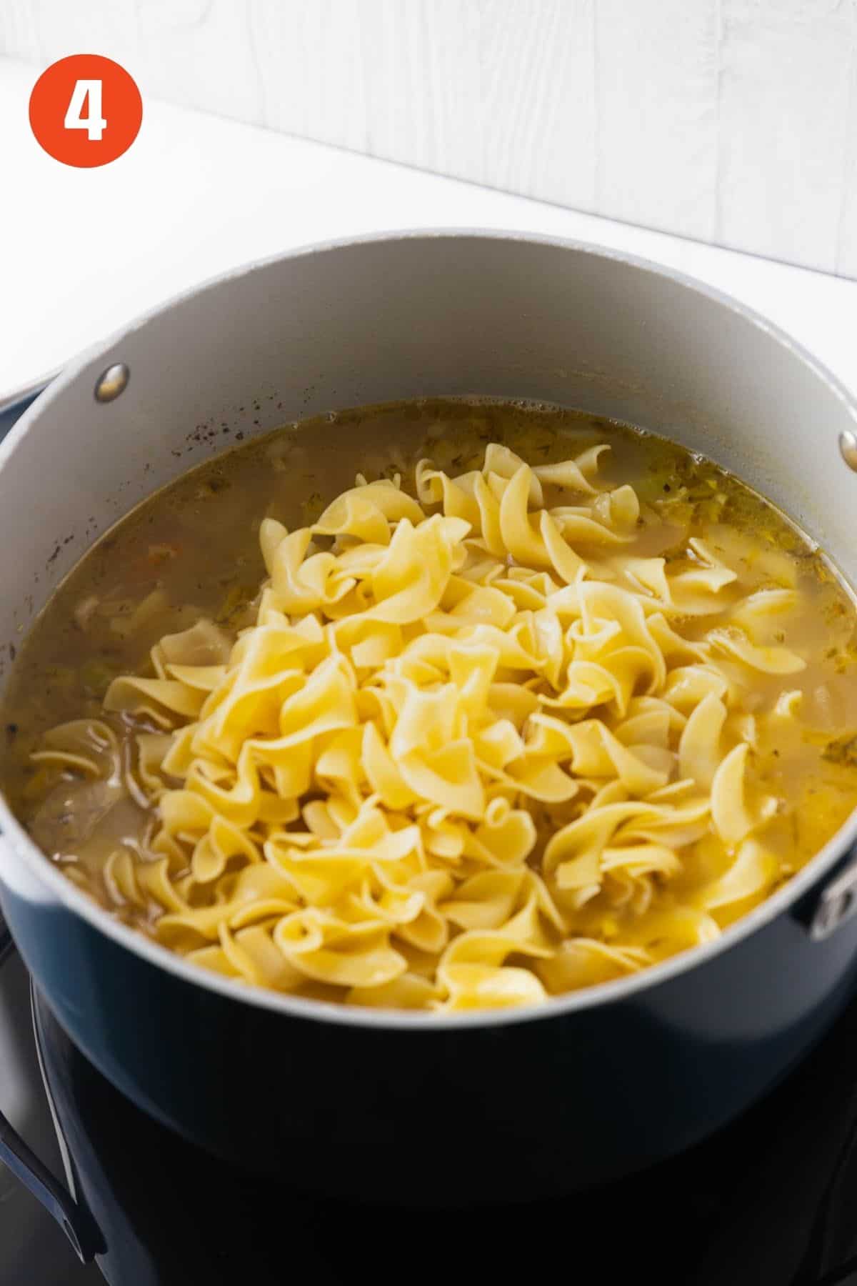 Noodles added to the pot of soup.