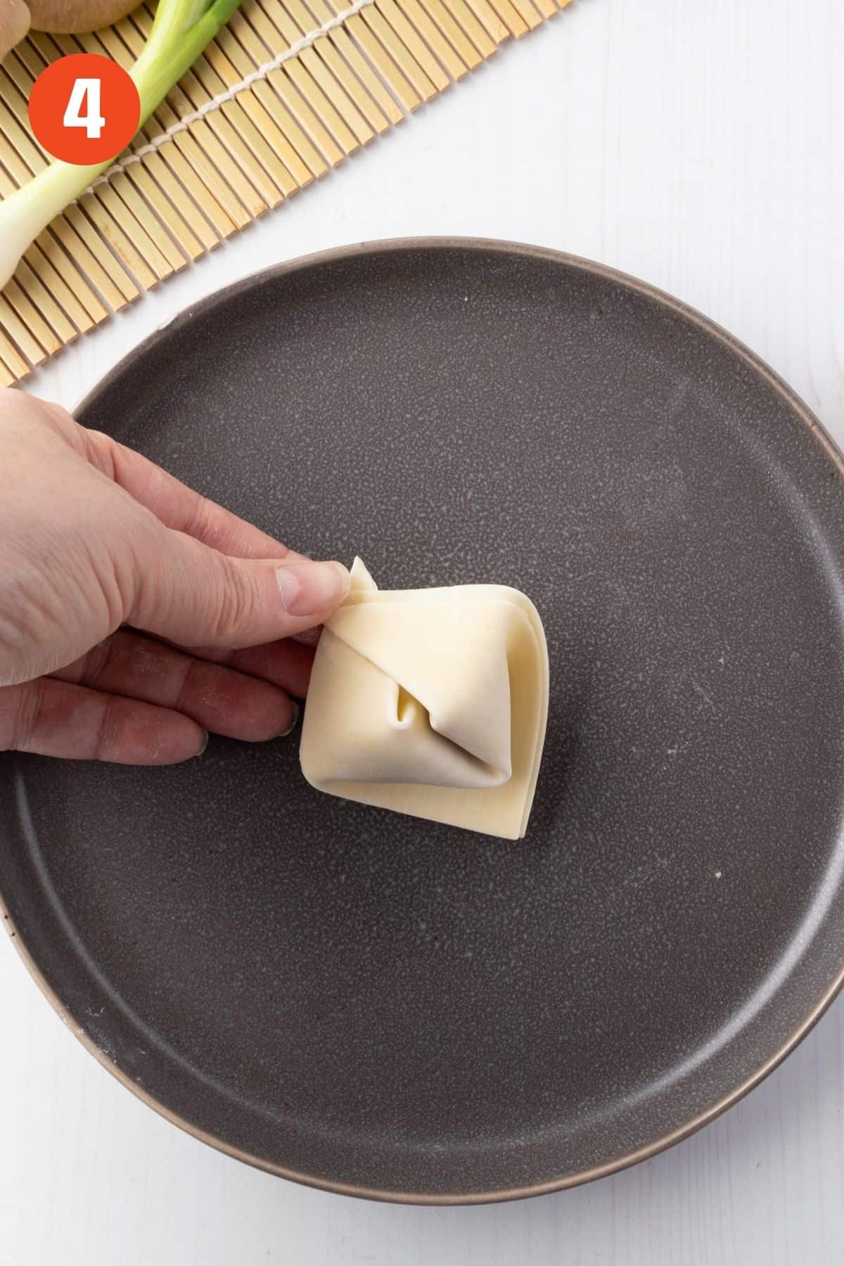 Corners pinched to shape the wonton.