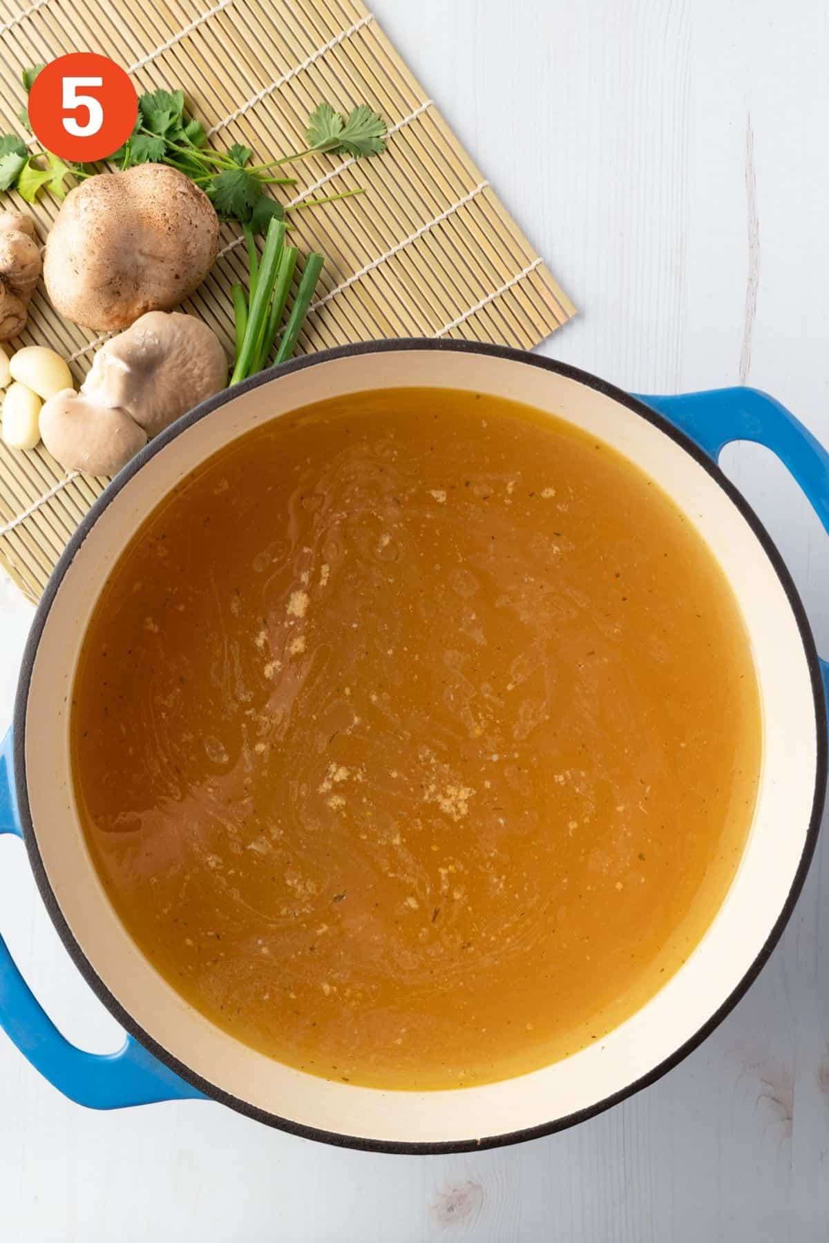Broth added to a pot to heat.