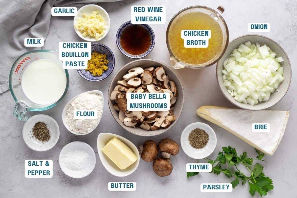 Ingredients to make this soup in bowls on a table.