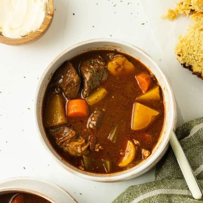 A bowl filled with Irish beef stew with potatoes and veggies.