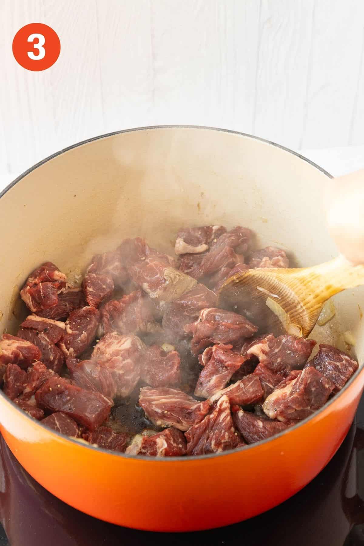 Beef browning into the pot.