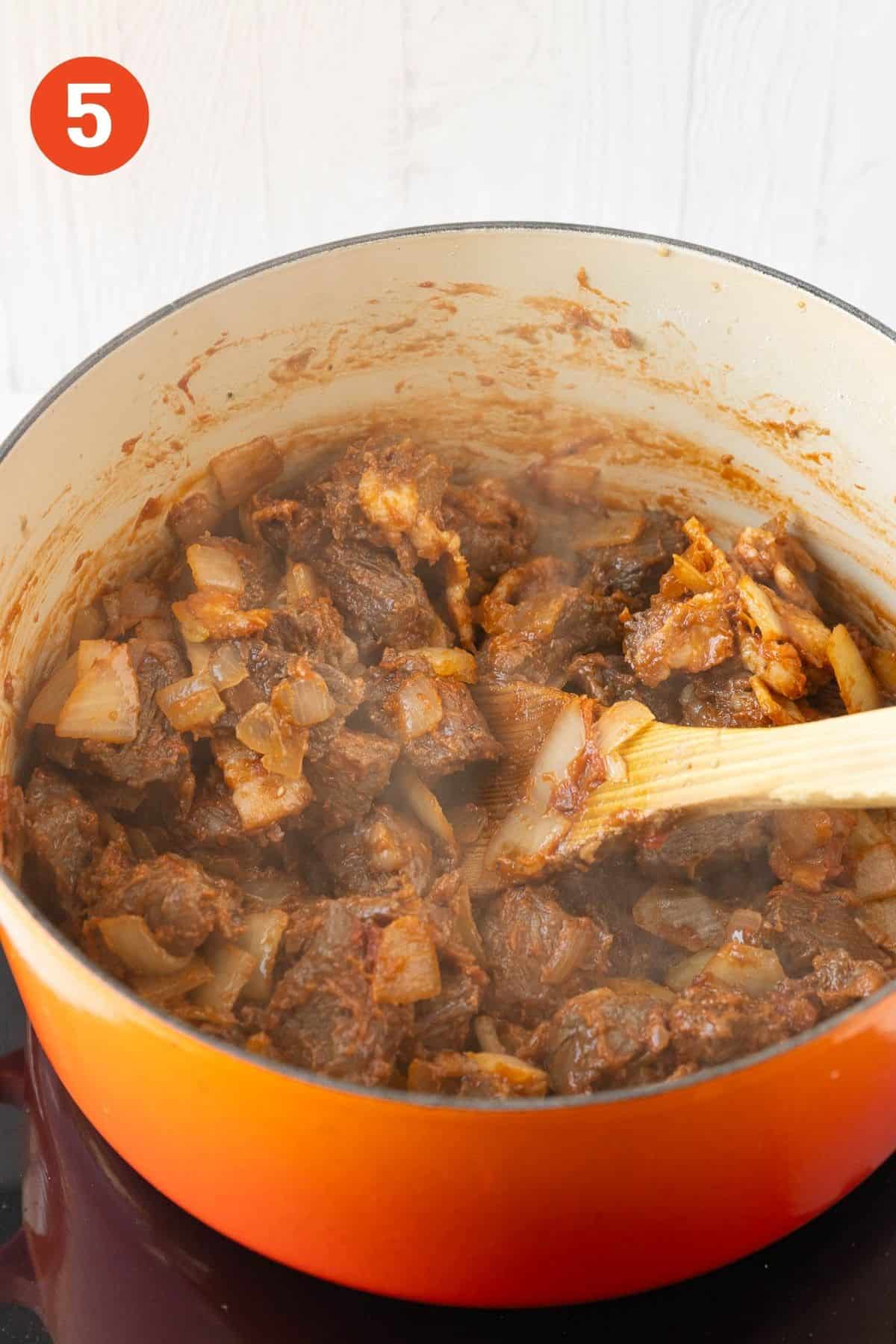 Tomato paste coating the beef.