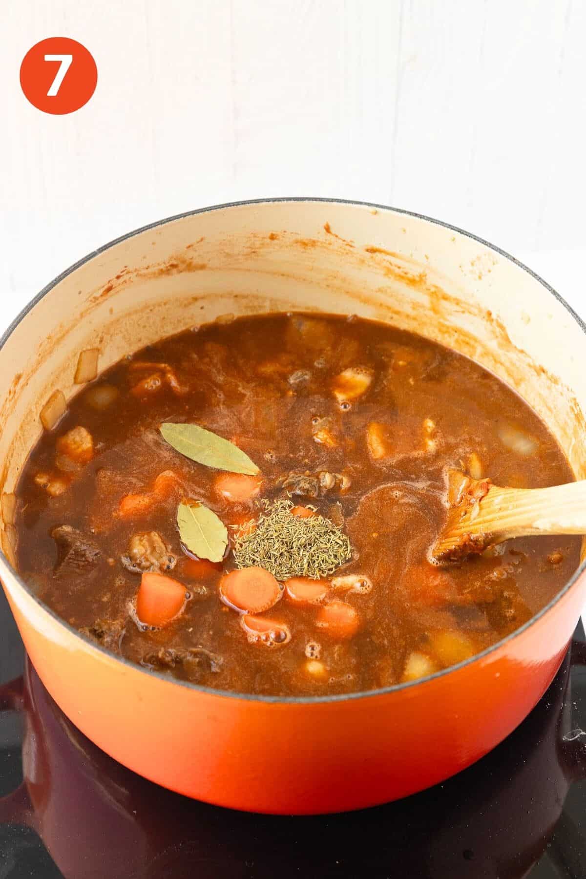 Bay leaves, thyme, Worcestershire sauce, and half the carrot added to the pot.