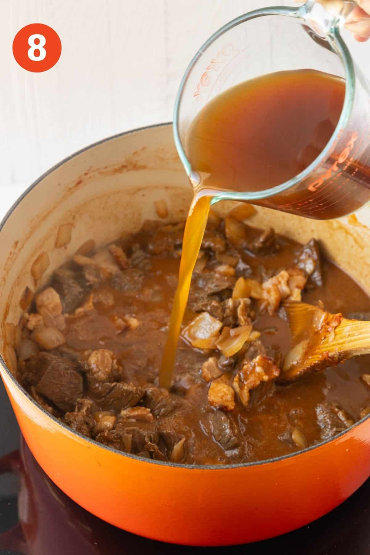 Beef broth being poured into the pot.