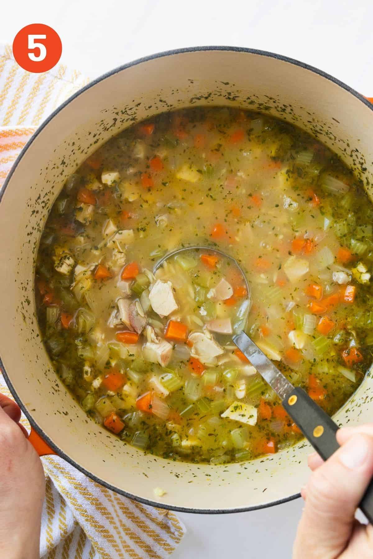 Chicken added and cooking to make chicken orzo soup.