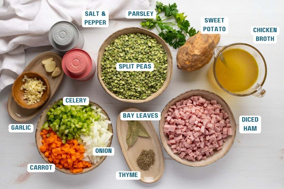 Ingredients to make this split pea soup in bowls on a table.