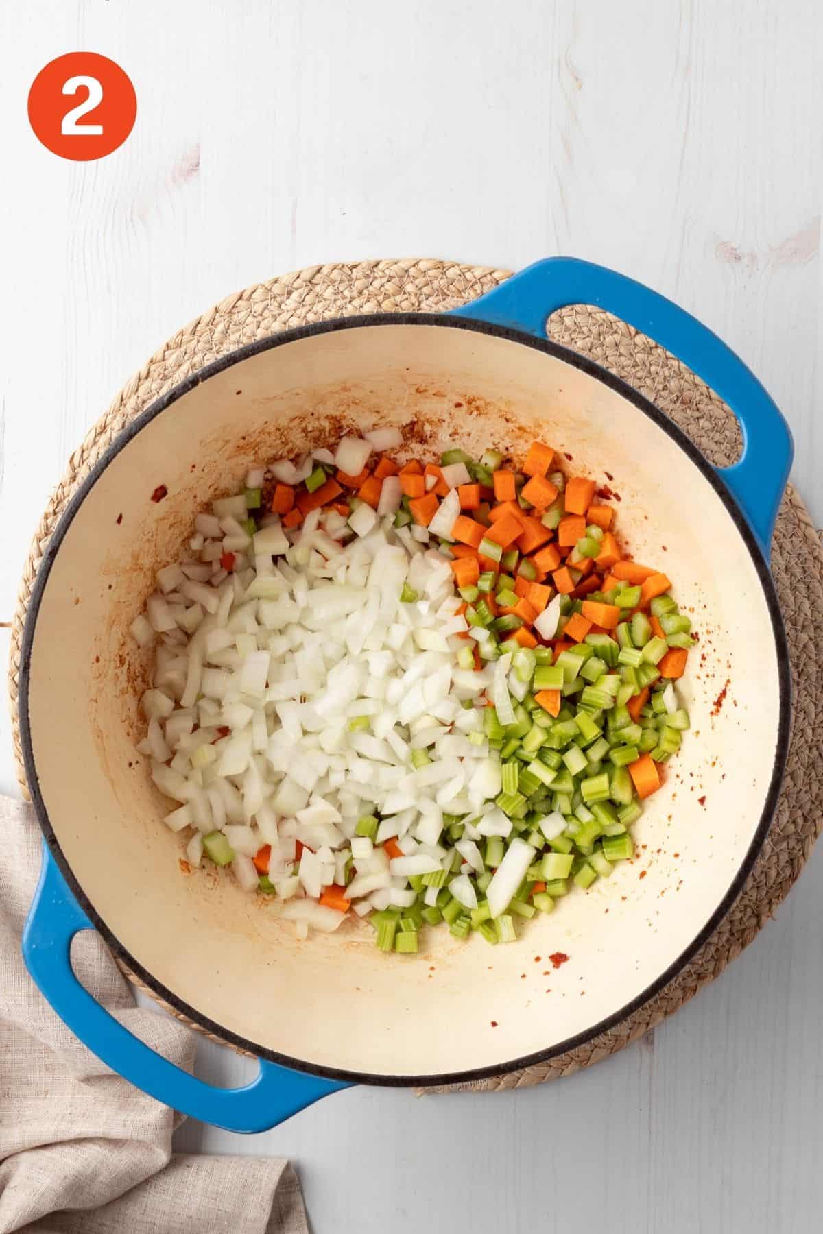 Celery, onions, and carrots cooking in the pot.