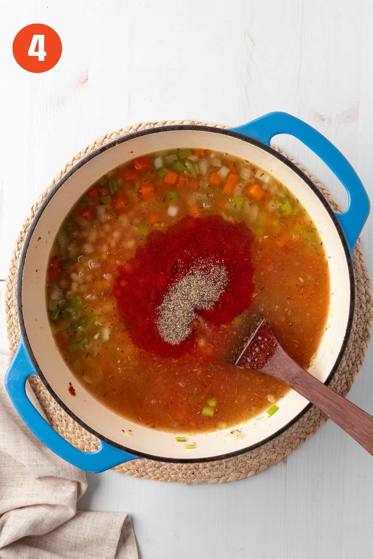 Broth, tomato sauce, paprika, salt, and pepper added to the pot.