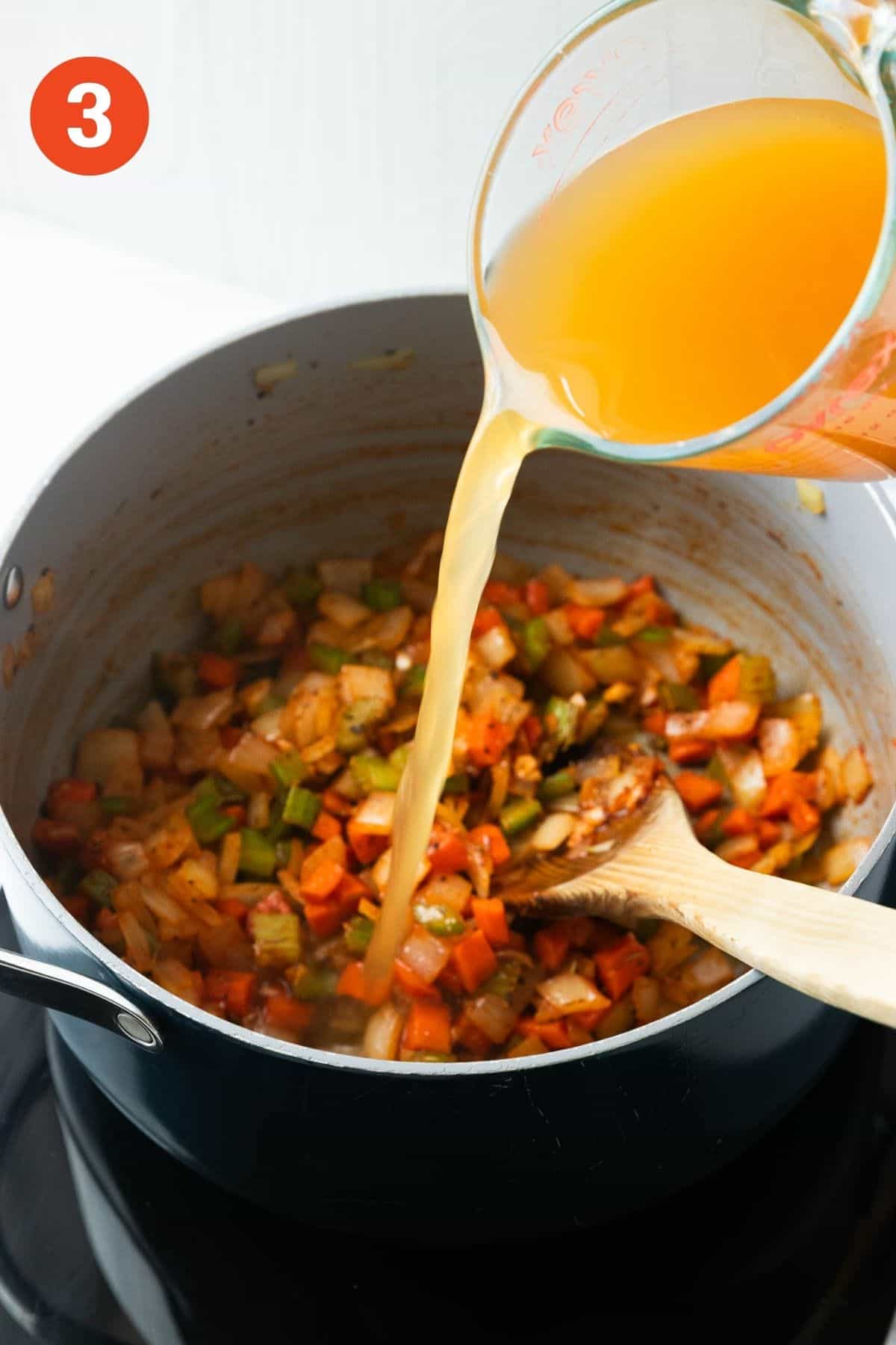 Vegetable broth being poured into the pot.