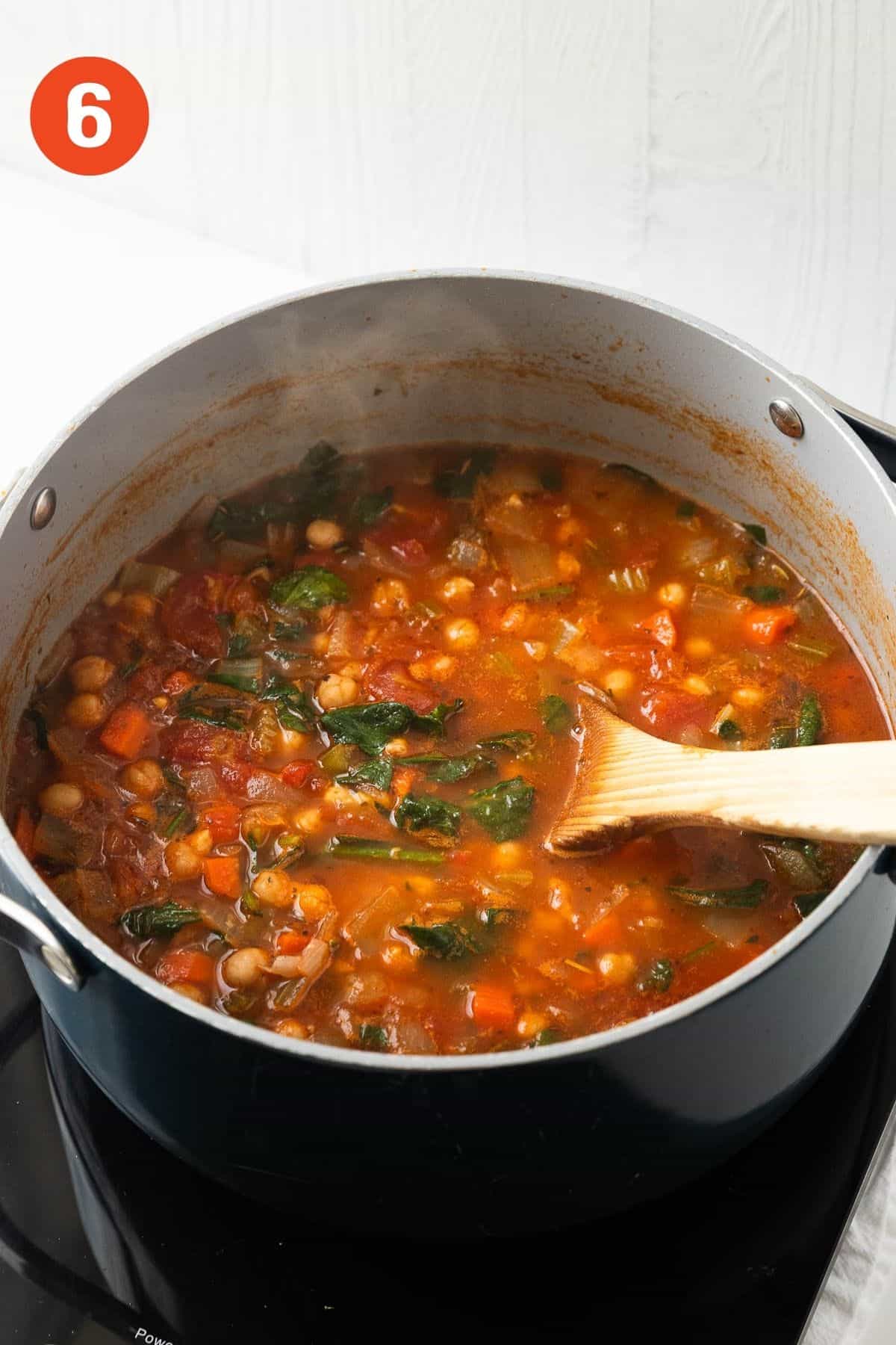 Spinach added to the soup to cook.