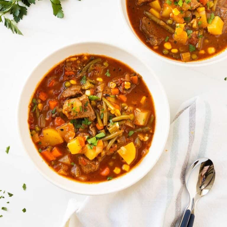 Vegetable beef stew in a white bowl.