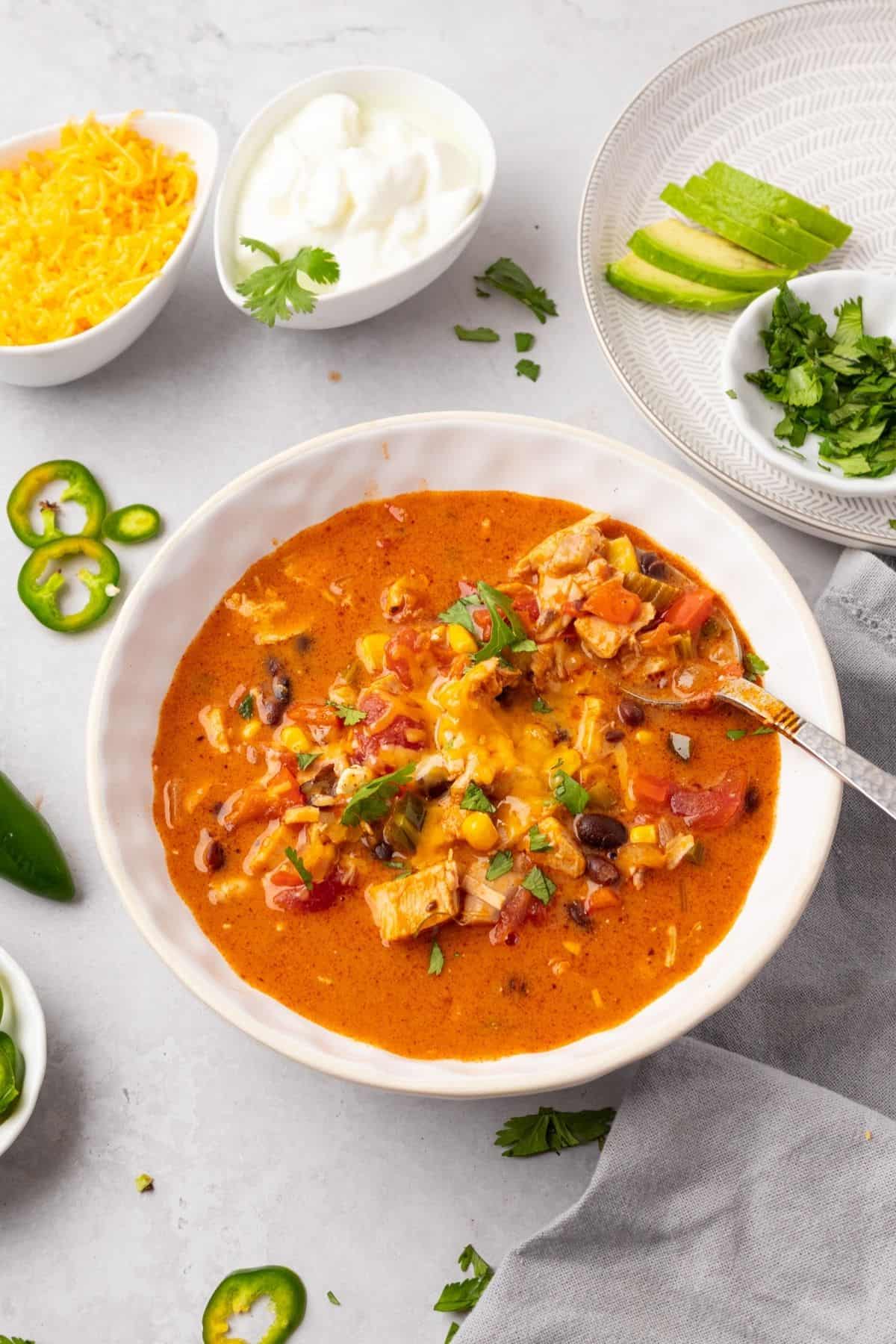 Cheesy chicken enchilada soup in a bowl.