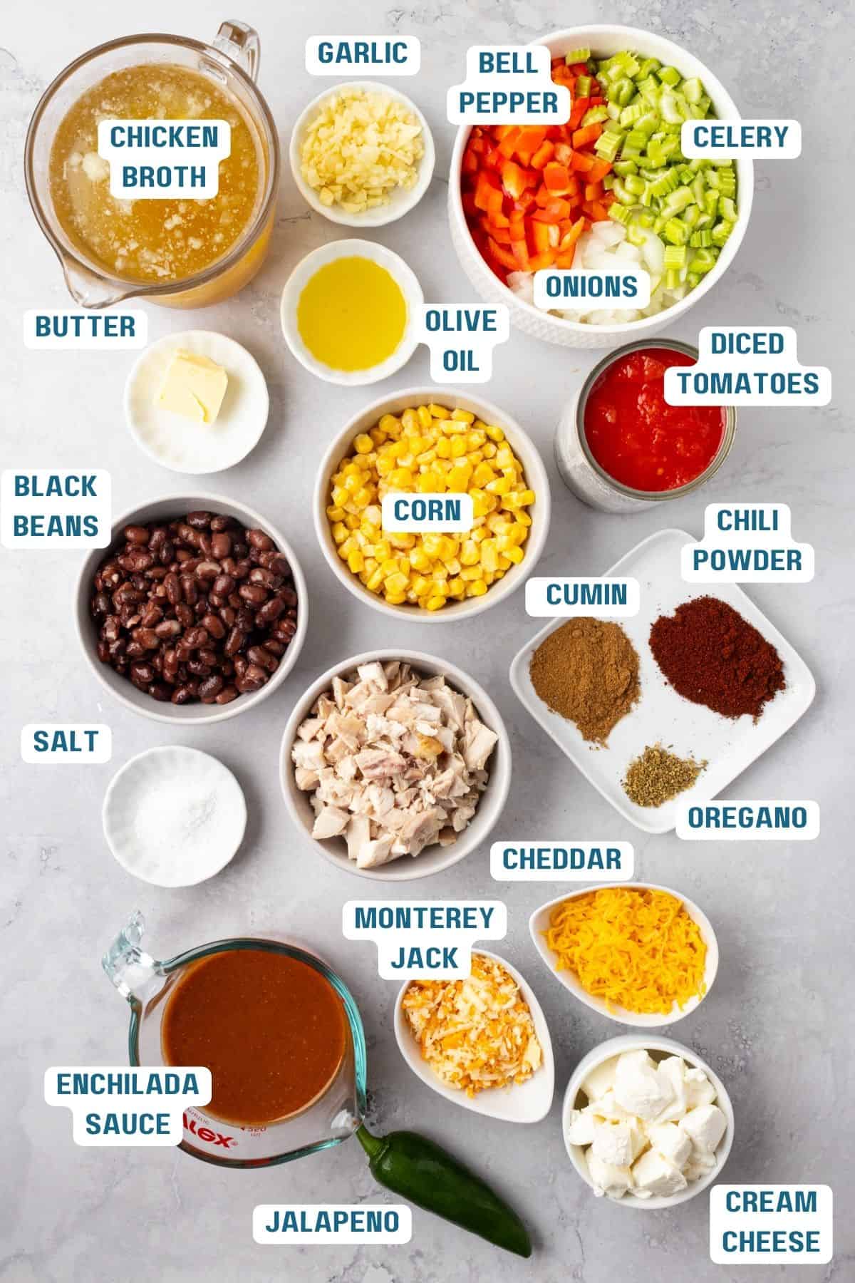 Ingredients to make chicken enchilada soup in bowls on a table.