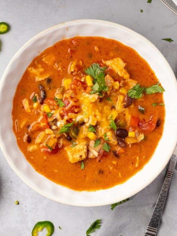 A bowl of cheesy chicken enchilada soup.