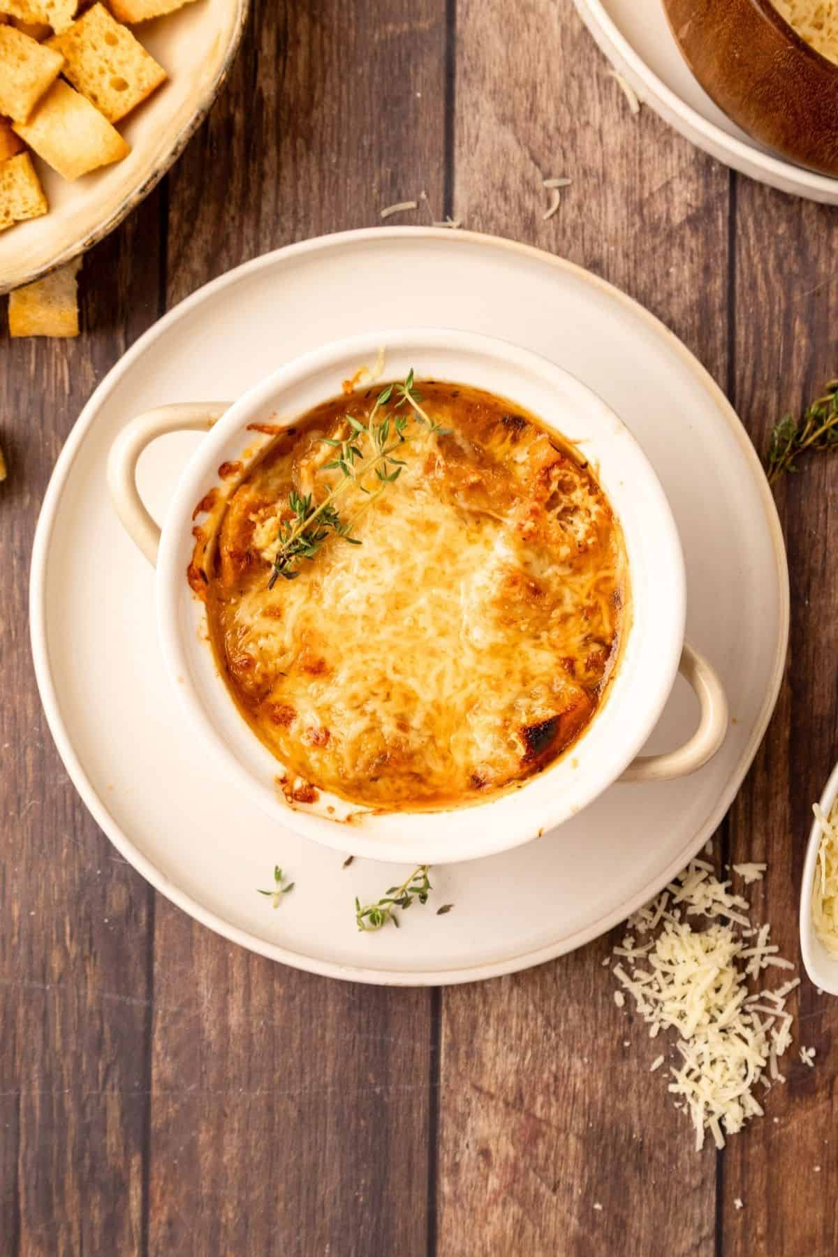 A bowl of French onion soup Panera copycat on a wooden background.