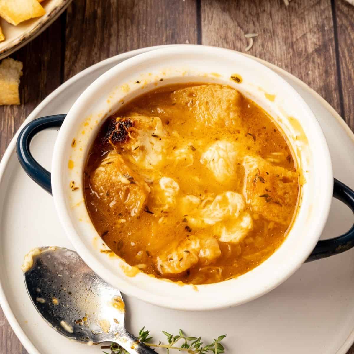 A bowl of Panera French onion soup copycat recipe on a plate.