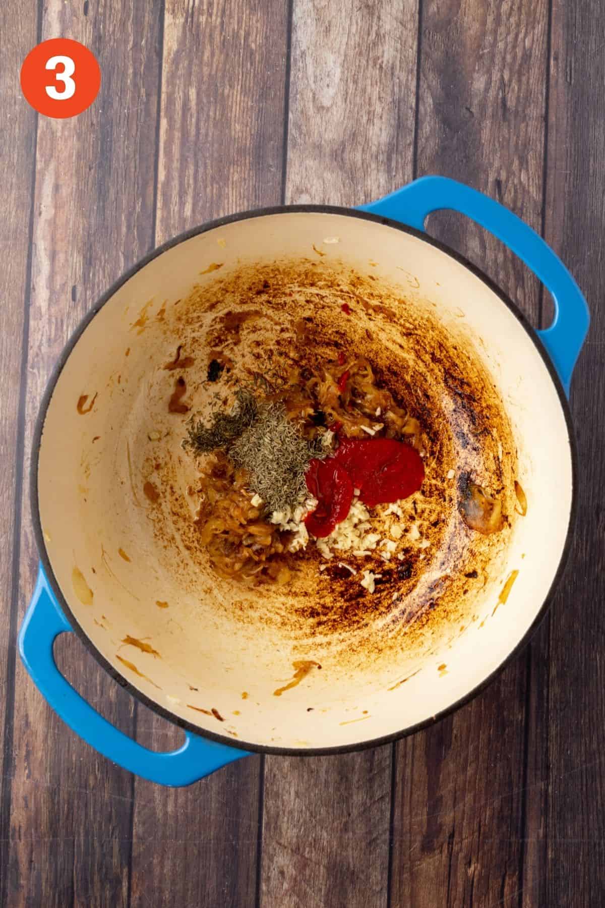 Thyme, tomato paste, and garlic added to the caramelized onions.