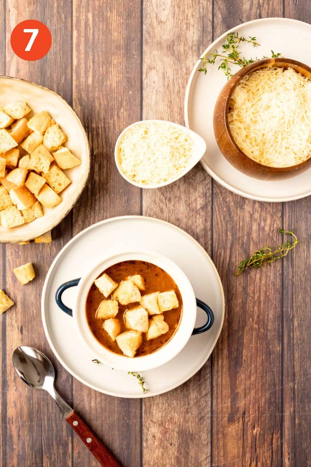 Soup ladled into a bowl and croutons added on top.