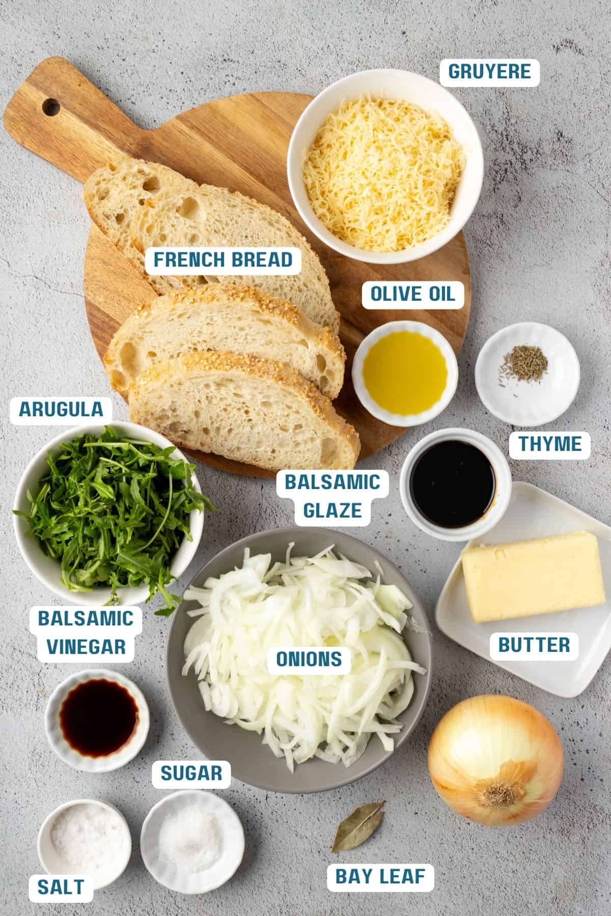 Ingredients to make a French onion grilled cheese sandwich on the table in bowls.
